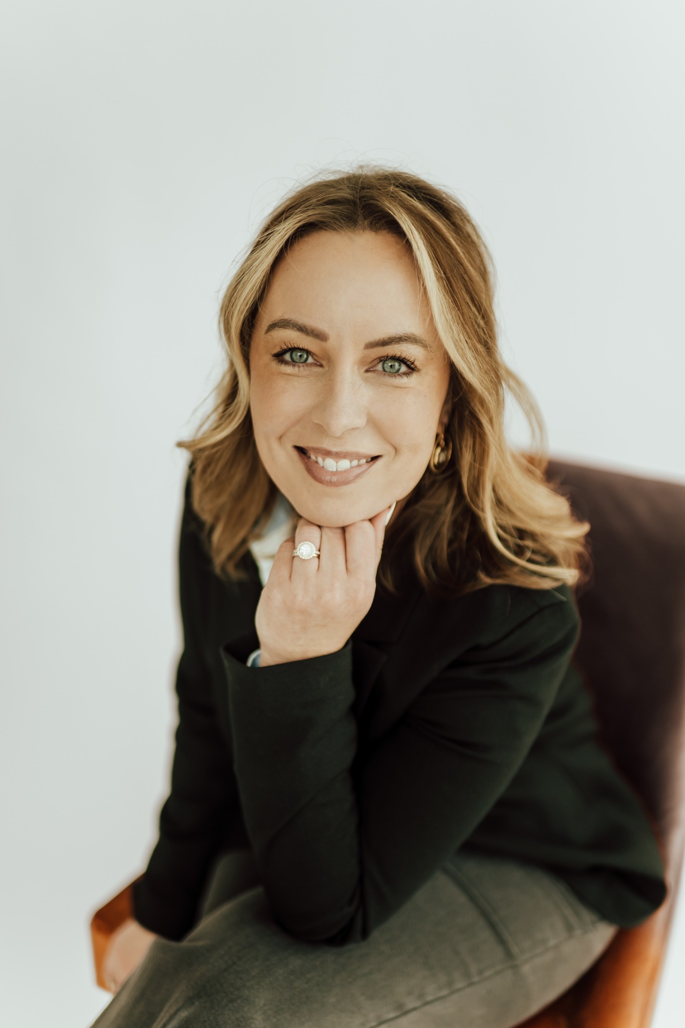 Portrait of Rachel Rowell smiling, resting her chin on her hand