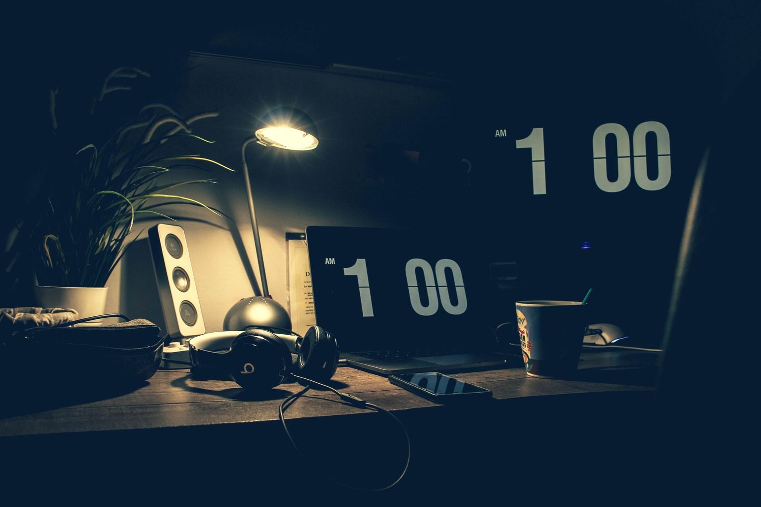 An empty business desk after hours, with notes and a computer