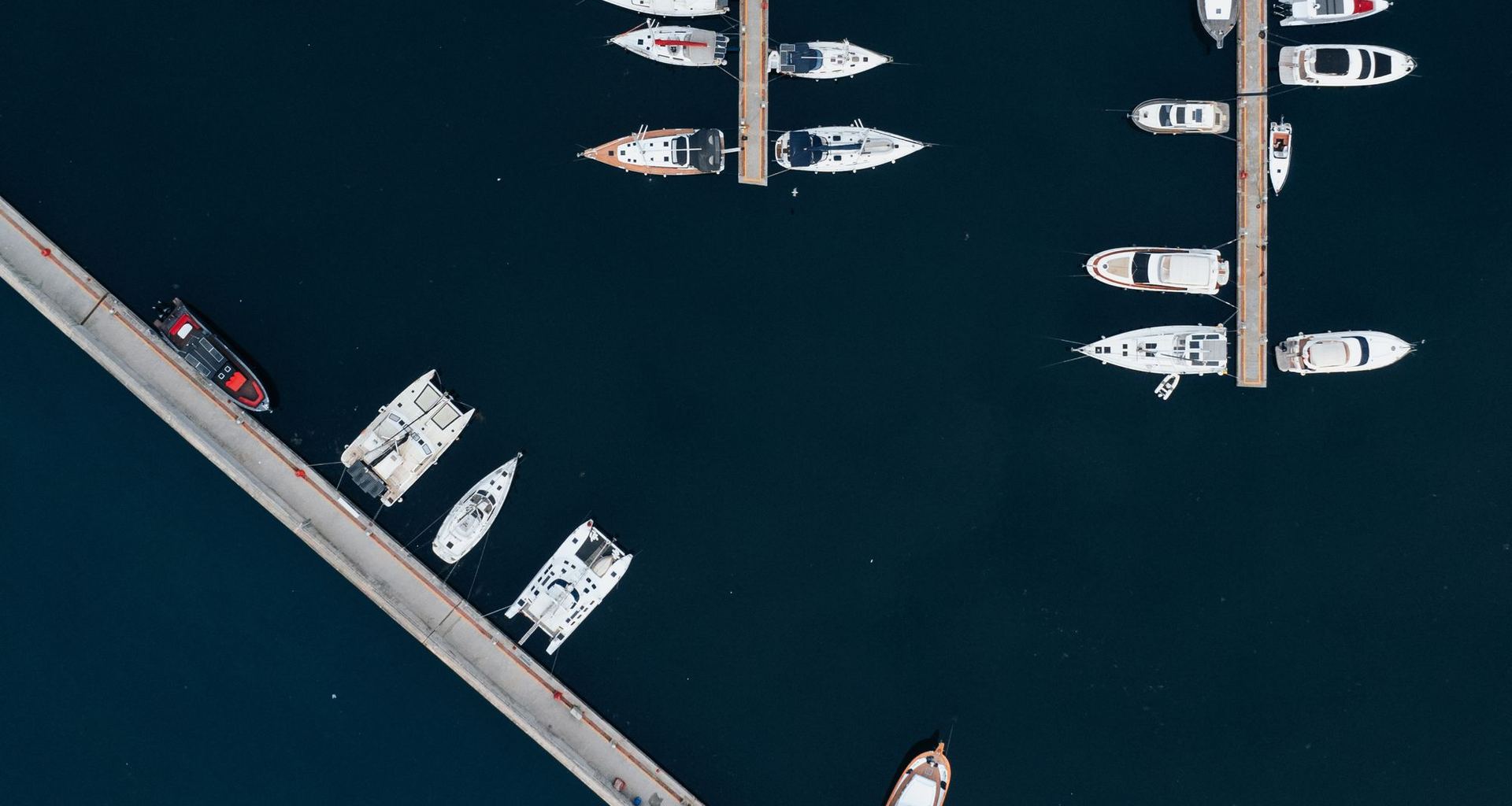 Aerial view of a marina, boats resting in their slips