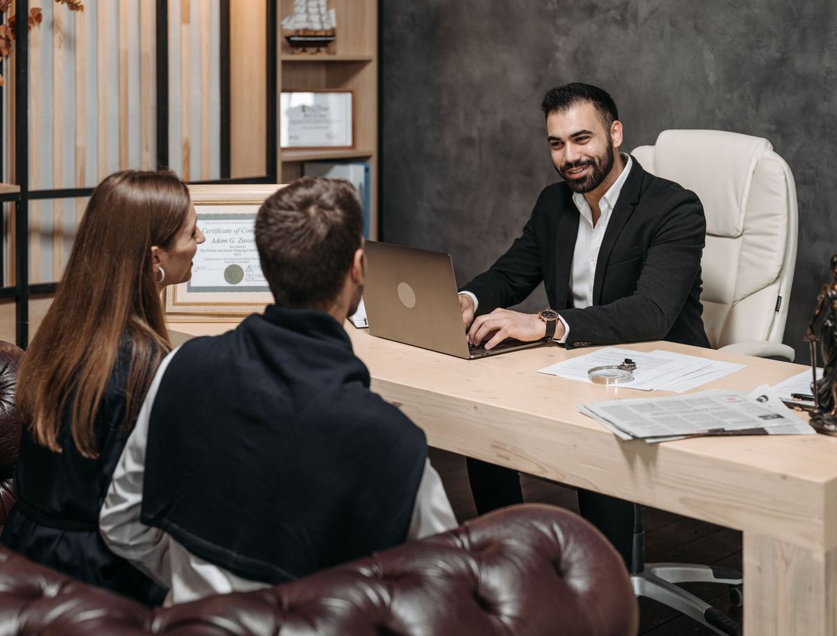 An attorney listening to a client during an office consultation