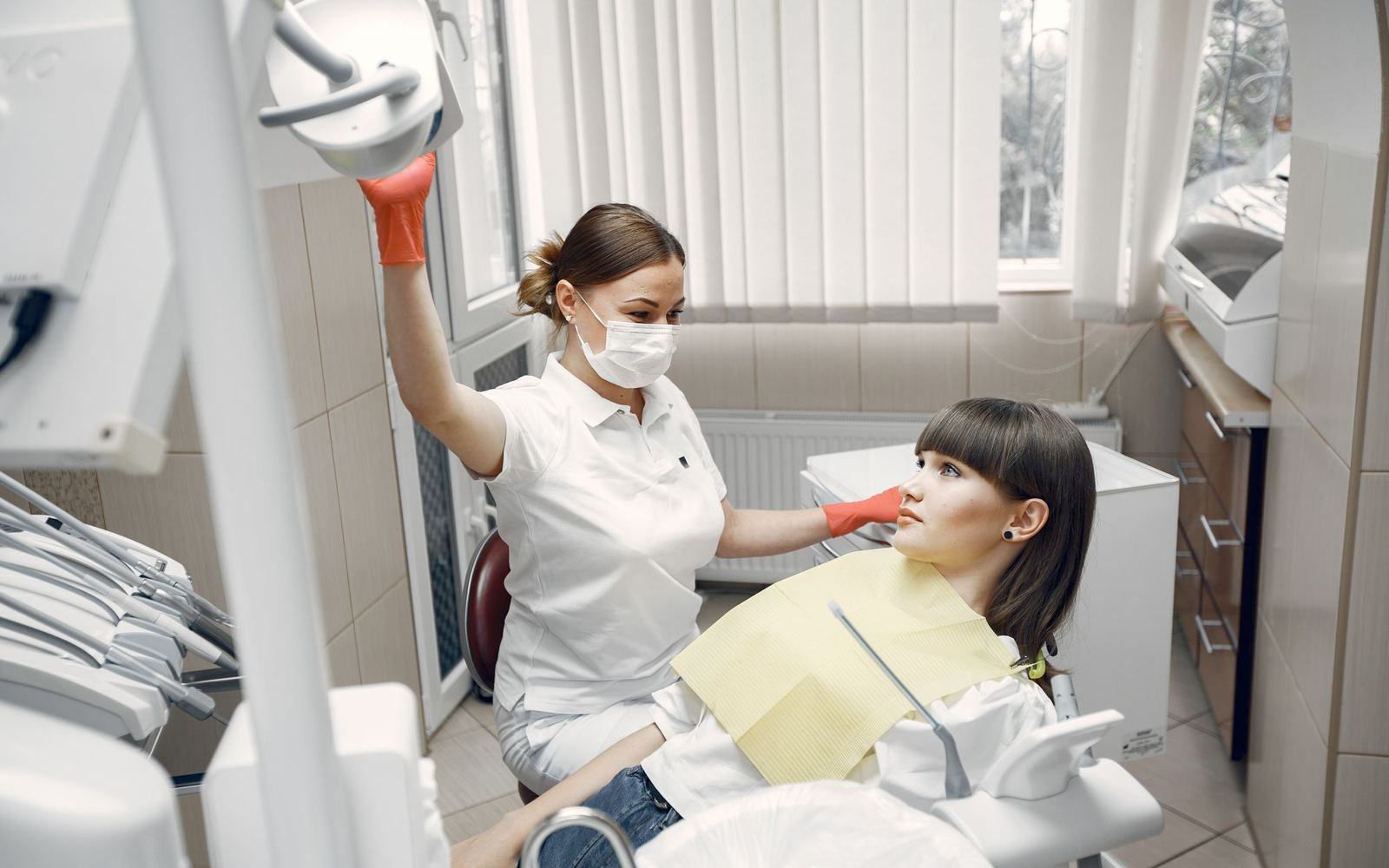 A dentist treating a patient in the chair