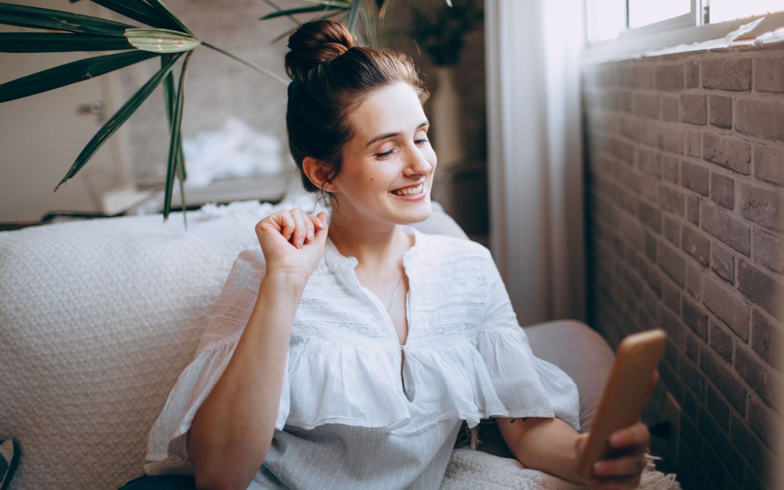 A woman at home looking something up on her phone