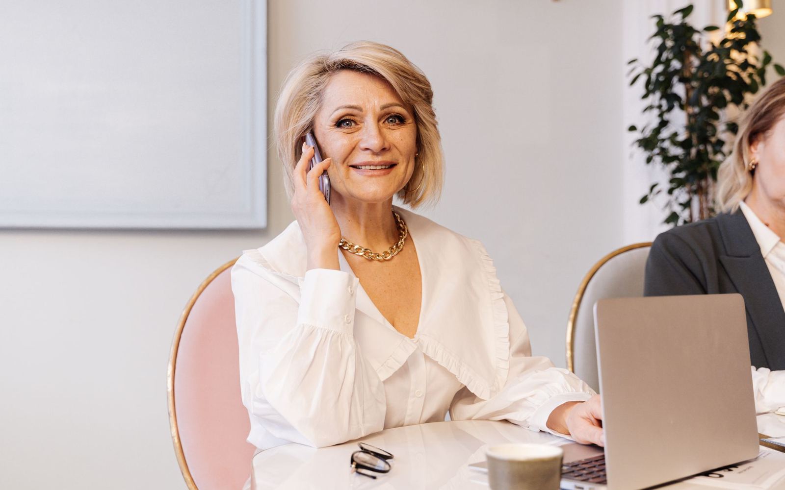 An office coordinator answering a phone call with a smile