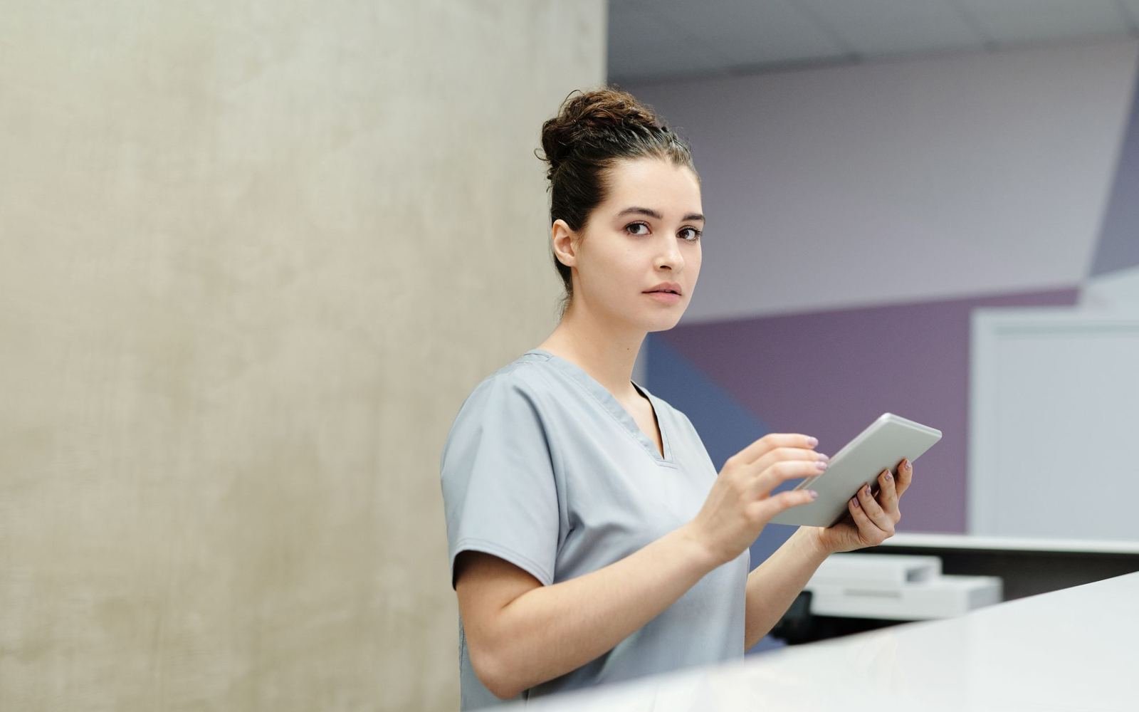 A front-desk coordinator updating details on a tablet