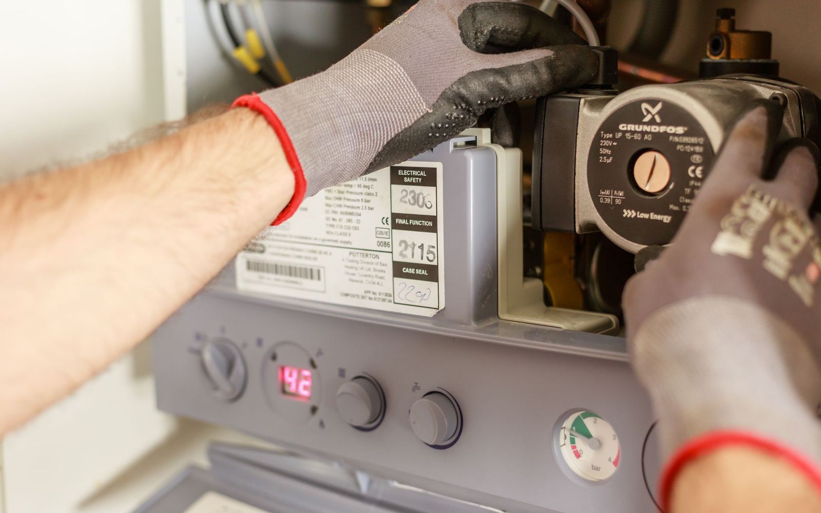 A technician adjusting a home water heating system