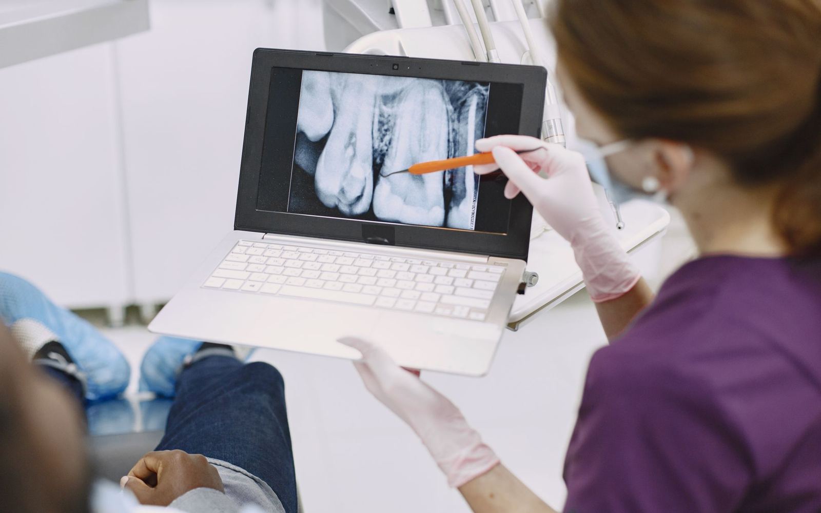 A dental professional explaining an x-ray to a patient