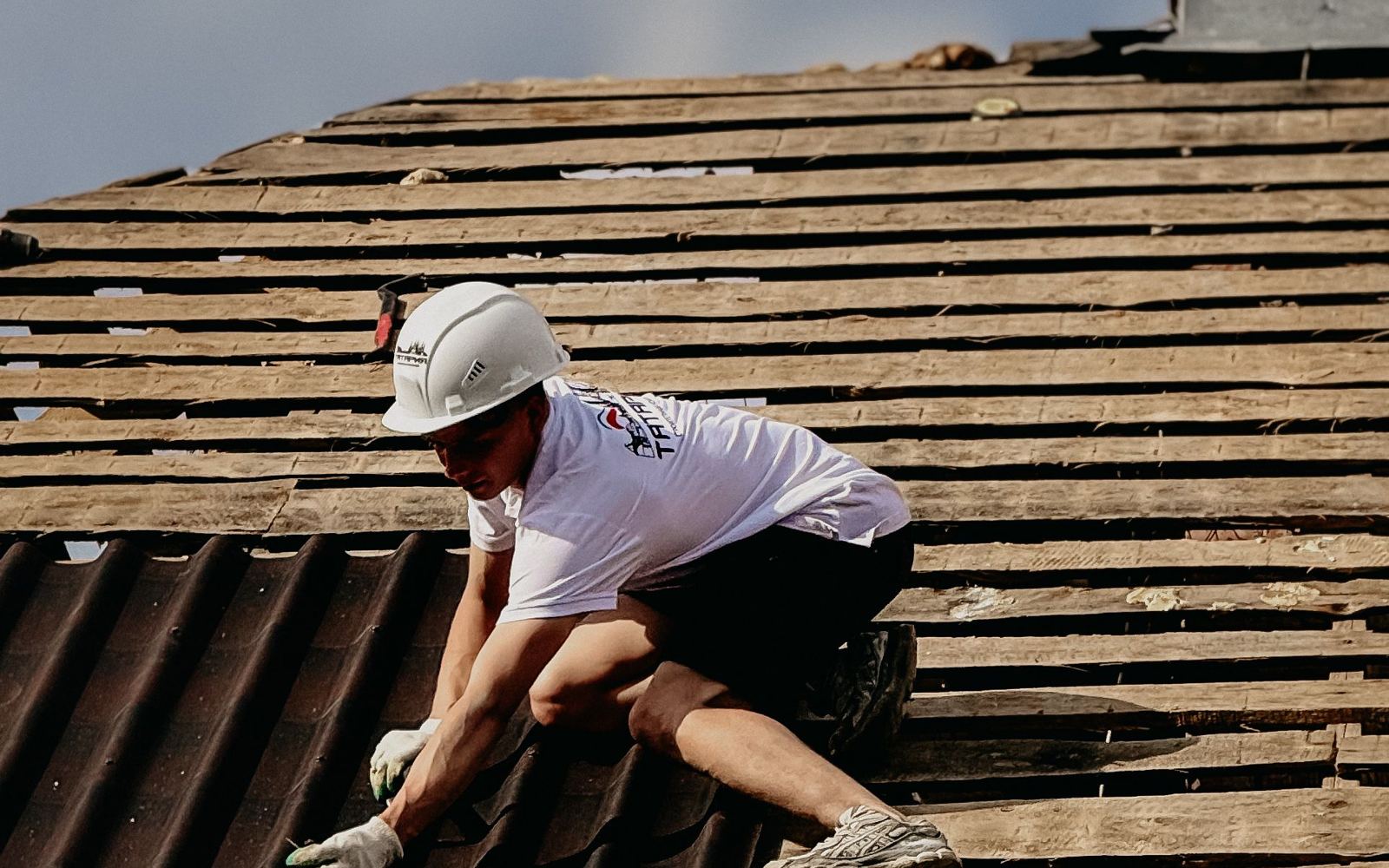 A roofer working on a sloped roof