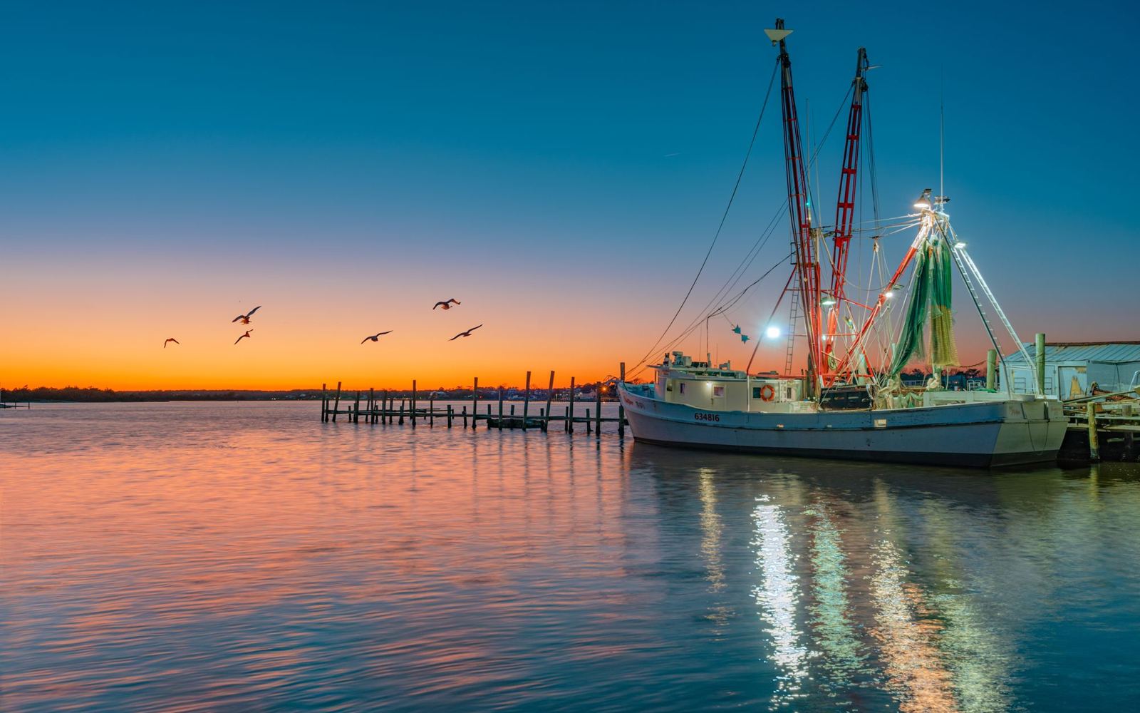 A fishing boat at a coastal North Carolina harbor at sunset