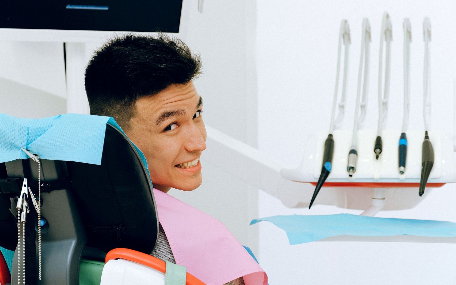 A cheerful patient in a modern dental chair