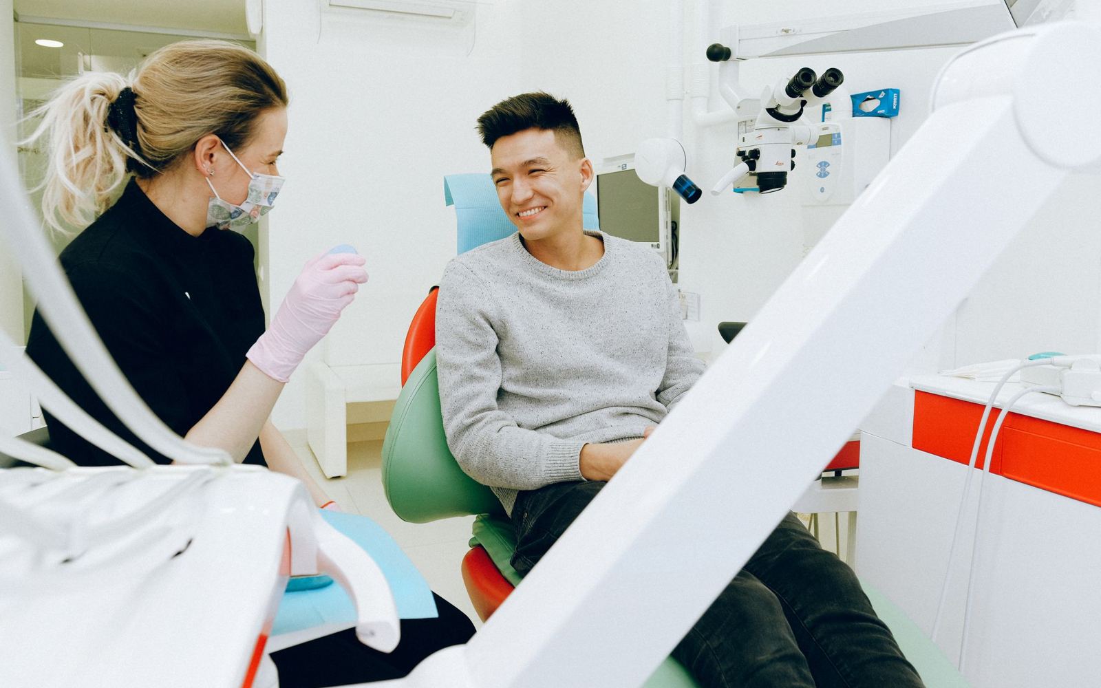 A dentist and patient sharing a relaxed moment during a checkup
