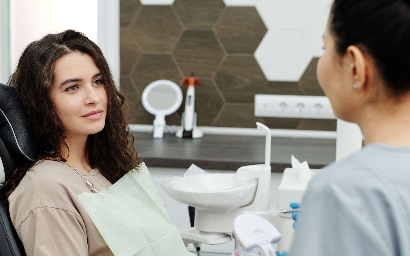 A dentist talking with a patient before treatment
